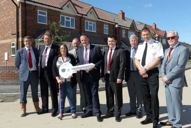 The official opening of the new housing project Smith Square by A1 Hosuing in Harworth. Sarah Cartlidge is pictured in front of her new home with councillors and team members.