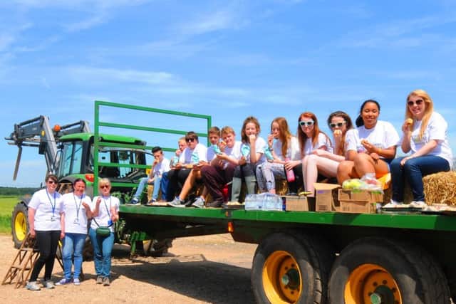 Tuxford Academy food forum students enjoy lunch on a trailer during their visit to Spittlemoor Farm
