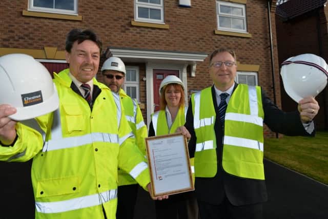 Jodi Wray and Trevor Durant from West Lindsey District Council presenting Rob Cucksey and Mick Burridge from Chestnut Homes with the final completion certificate for Foxby Chase last year