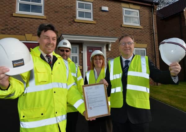 Jodi Wray and Trevor Durant from West Lindsey District Council presenting Rob Cucksey and Mick Burridge from Chestnut Homes with the final completion certificate for Foxby Chase last year