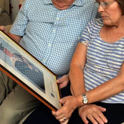 Brian and Irene Birkett with a photograph of their Son Brian
