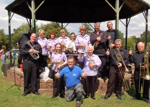 Langold Lake Gala, Paul Wrobel, chairman of Friends of Langold Country Park celebrates with Thurcroft Colliery Band as news of funding available to restore the old bandstand (w110712-7c)