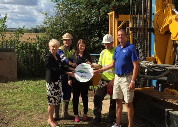 Councillor Liz Redfern, SDF Panel member and North Lincolnshire Council Leader, Jade Fearon, SSE Liaison Manager, and Rob Jenkins, General Manager Epworth Swimming Pool, with two construction workers for the project.