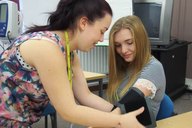 Estelle Cocking, right, from Gainsborough, learns how to take blood pressure with fellow healthcare cadet Demi Walker