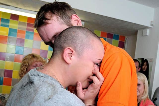 Charlotte Whiteley (22) from Worksop had a Her head shaved for Macmillan Nurses charity.The hair loss took place at Restyle Hairdressers on Potter street, Worksop.Denise Wheatcroft, Mother of Salon owner Shelley Wheatcroft took the shears to Charlotte's locks, after Charlotte made the first cut herself.A crowd of Friends, Relatives & work colleagues gathered to watch the event.A hug from her Fiance Mark Wilson, helped a tearful Charlotte cope with what she had done."We hope to have raised over £1,000 in total" said CharlotteNWGU 19-9-15 Headshave, What have I done, Charlotte with Fiance Mark Wilson (5)