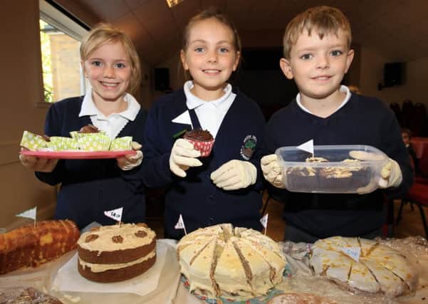 Wroot Travis Primary School children held a Macmillan coffee morning at Wroot Village Hall. Pictured are Daisy Walker, nine, Christy Monument, nine, and Rowen Petch, nine.