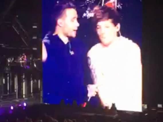 Footage has emerged of on-stage tensions between members of One Direction - with Liam Payne SHOVING Louis Tomlinson during an apparent tiff