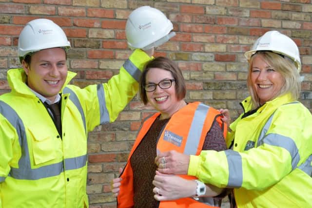 Chestnut Homes Director Robert Newton and Sales and Marketing Manager Barbara Goodwin (left and right) show how visitors will be kitted up in hard hats and high-vis vests at the event