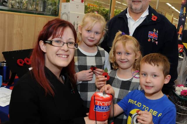 Gainsborough Standard reporter, Shelley Marriott with Dave Freestone from the Gainsborough RBL and Leo, Caitlin and Caisey Greaves who bought their poppies at the town's Morrison's store.