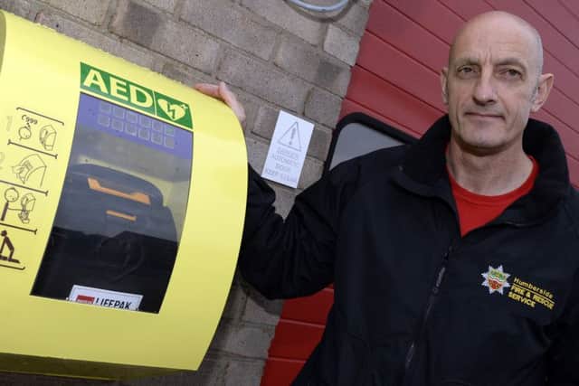 John Armson from Humberside Fire and Rescue by the new defibrillator that has been installed at Crowle Fire Station