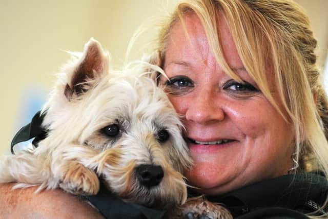 Jerry Green dog rescue centre feature.Volunteer, Gill Skinner, with Oscar, the Westie that she has adopted.
