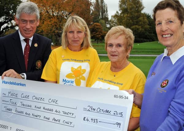 Christine Walker, right, the Lady Captain of 2014 at the Lincoln Golf Club, presents the proceeds of her years' fundraising, totalling £4933.99, to Marie Curie representatives, Anne Looker and Robina Cameron, who nursed Christine's husband Gordon, in whose memory the presentation was made. Also pictured is John Haycox who was Captain during the same year and raised a similar amount for Multiple Sclerosis.