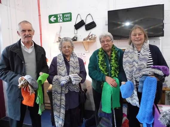 Members of Retford U3A witth items of knitwear they are donating to HOPE