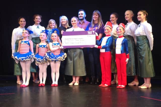 Community Fundraiser Mel Rose receiving a cheque with Rebeccas Dance Studio at the Proud event