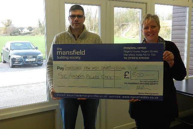 Brian Seddons, from The Mansfield, presents the cheque to Rachel Barrowcliffe from Shireoak Sports & Social