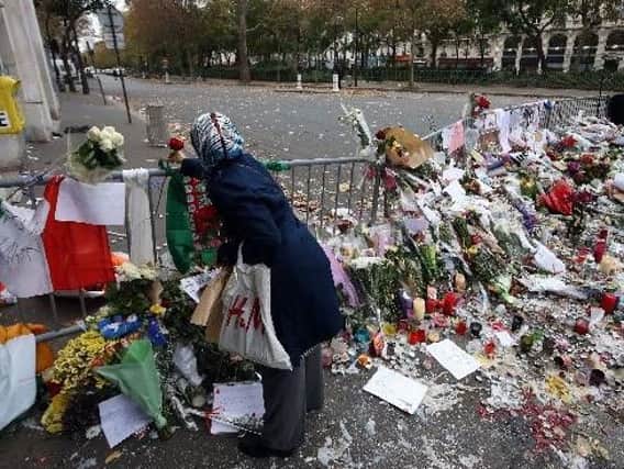 Floral tributes left near the Bataclan concert hall in Paris following the terrorist attacks in November. Picture: Steve Parsons/PA Wire