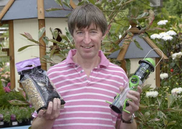 Peter Burks from online garden centre Potter and Rest with some of their bird feeding products