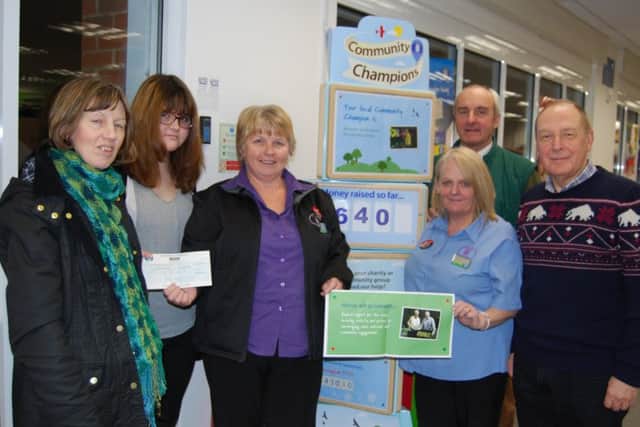 Representatives from Misterton show have been presented with a cheque for £640 by Co-op store manager, Brenda Gleadle (centre left) and community liaison representative Caroline Harrop (centre right)