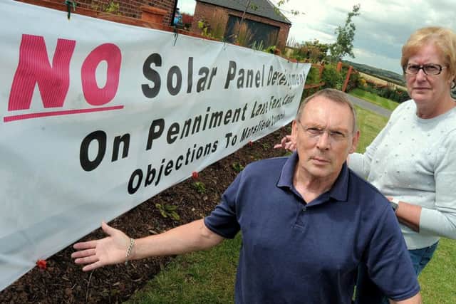 Geoff McCormack & Ann Rose who are amongst the local residents objecting to a planned Solar farm to be erected in  fields close to Penniment Lane on the Mansfield  / Sutton in Ashfield border.NMAC 30-7-15 Solar, Solar Farm objectors Geoff McCormack & Ann Rose with the huge Banner on one of their properties to get across their message( 1 to 4)
