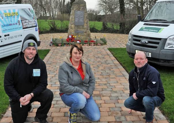 Keeley Ward, chairman of the Bilsthorpe branch of the Royal British Legion with local tradesmen who volunteered their services to clean up the village memorial, they are Lee Greenacre, left, from Mr G's Windows, who power washed the memorial, and Simon Tunnicliffe who did the groundworks.