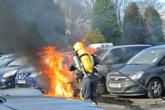Firefighters tackle a car fire in a car park in Chapel. Credit: Nigel Pickover