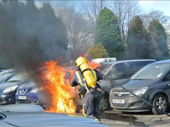 Firefighters tackle a car fire in a car park in Chapel. Credit: Nigel Pickover