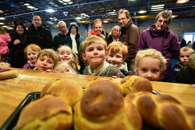 Children watching a bread making demonstration