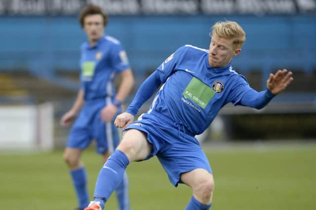 Gainsborough Trinity vs Aston Utd. Simon Russell on the ball
