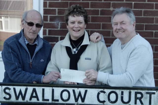 Coun Hazel Brand has presented a cheque for £50 to Cedric Hancock and Geoff Richardson.