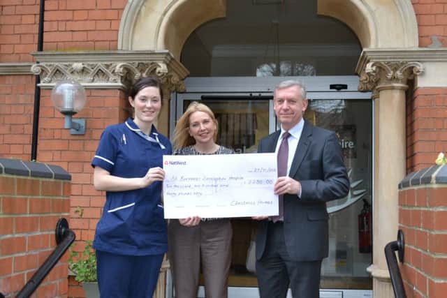 Sarah Jowett and David Newton of Chestnut Homes present a cheque to St Barnabas Lincolnshire Hospice