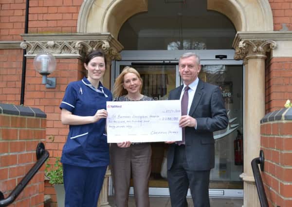 Sarah Jowett and David Newton of Chestnut Homes present a cheque to St Barnabas Lincolnshire Hospice