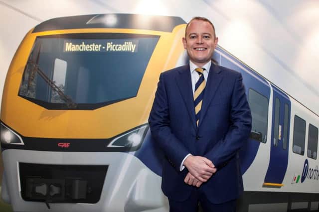 Alex Hynes, Managing Director of Northern, with a visualisation of a new-look Northern train on the first day of the Northern Franchise