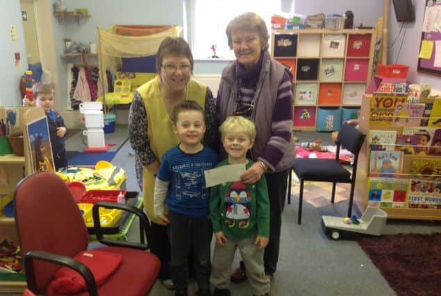 Bassetlaw councillor Joan Sanger presents a cheque to Shirley Baker at Speckled Frogs in Beckingham
