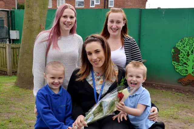 Guardian Rose presentation to St AugustineÃ¢Â¬"s teacher Devon Huxley-Worn, Devon is pictured recieving her rose from Natasha Austin and daughter Jasmin, five and Natalie Watkinson with son Kayden, four
