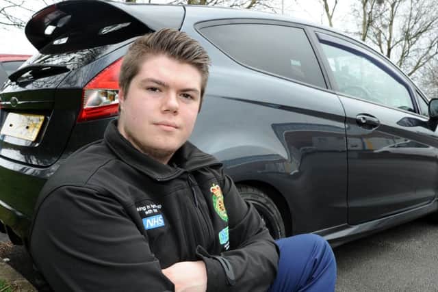 Scott Rathbone with his car that was vandalised.
