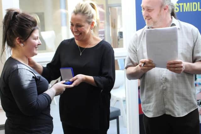 Stacey receives her award from judges Sarah Harrison and Derek Fenney