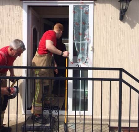 The scene at a property on Harpswell Hill in Gainsborough where firefighters had to perform a 'controlled breakage of glass' to rescue an elderly woman.