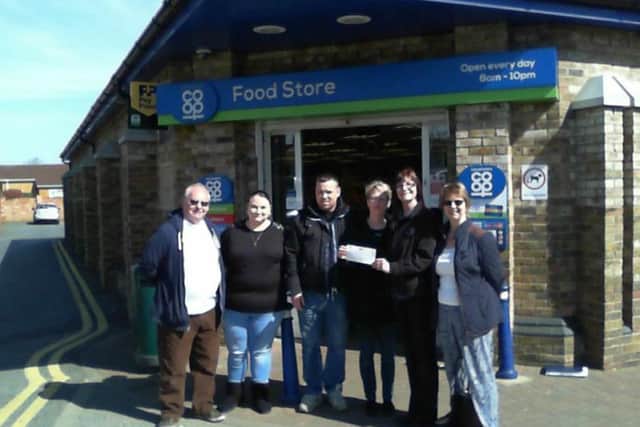 Co-op store manager Julie Rumbelow (second right) presents the cheque to GAPS committee members (from left) Mick Thrower, Gemma Roberts, Andy Fox, Yvonne Clark and Kim Basu
