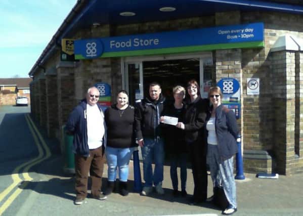 Co-op store manager Julie Rumbelow (second right) presents the cheque to GAPS committee members (from left) Mick Thrower, Gemma Roberts, Andy Fox, Yvonne Clark and Kim Basu