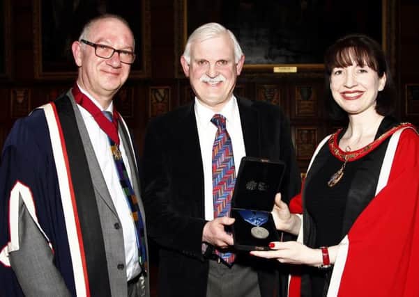 Vice President of the RCPath Dr Lance Sandle (left) with President of the RCPath Dr Suzy Lishman presenting Dr Cowling with his medal.