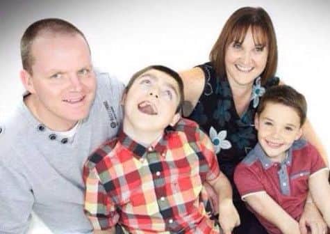 Aaron Faulkner with mum Joanne, dad Lee and brother Matthew