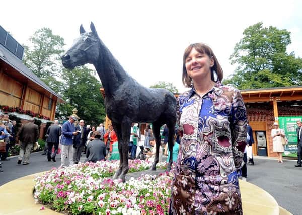 LADY AND THE CHAMP -- a statue of the mighty Frankel at York racecourse is admired by Lady Jane Cecil, widow of the wonder horse's late, great trainer, Sir Henry Cecil. Frankel's first foal won on debut last Friday.