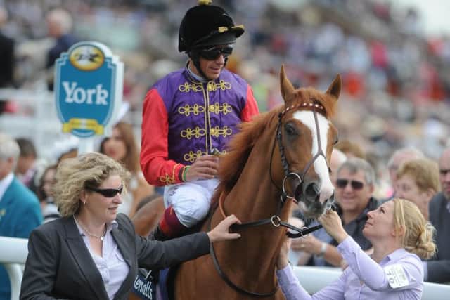 BY ROYAL APPOINTMENT -- Frankie Dettori sporting the royal silks on a winner owned by The Queen. Jockey, colours and owner are sure to be to the fore at Royal Ascot next week.