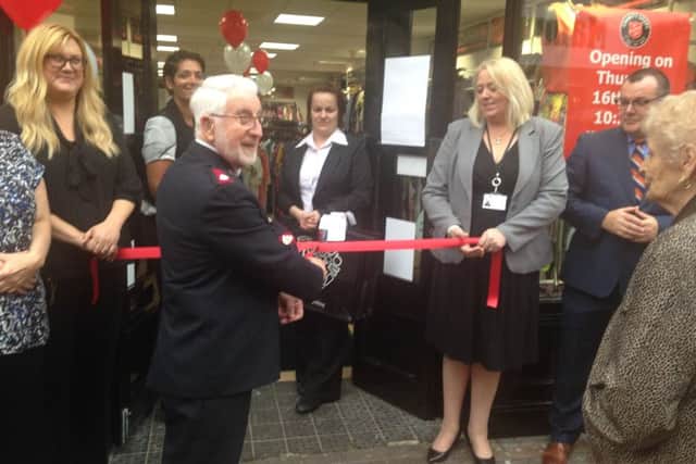 Major Ray Mackereth cuts the ribbon to officially open the new Salvation Army shop in Retford