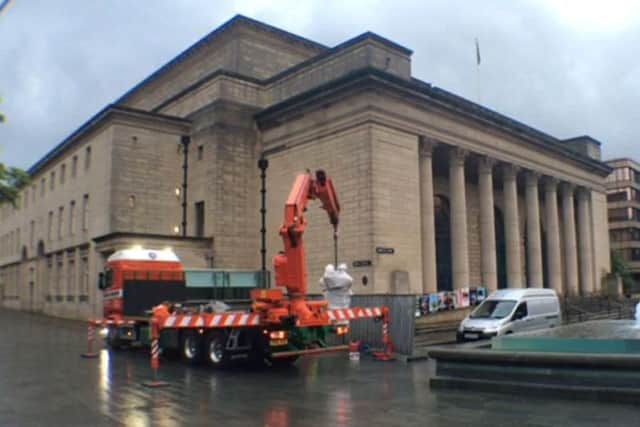 Women Of Steel statue is craned in to position in Barker's Pool, outside Sheffield City Hall.