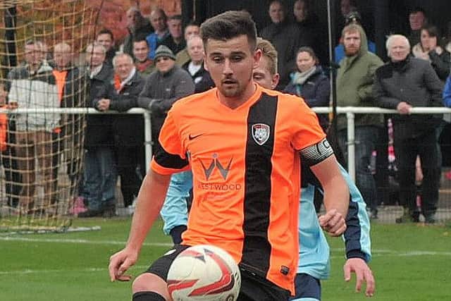 Conor Higginson wearing the armband for Worksop