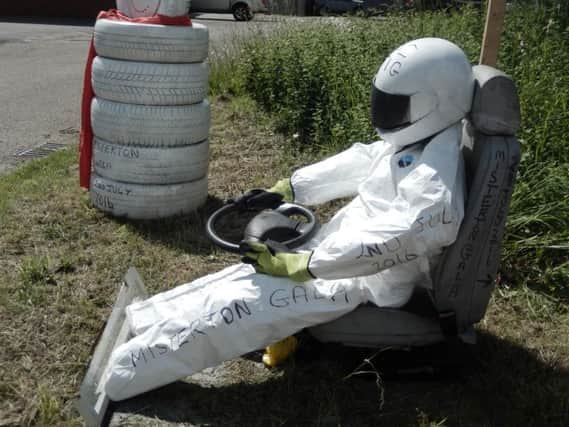 A Stig-Crow outside KSS Tyres in Misterton is part of the annual village gala's scarecrow competition