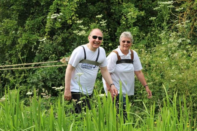 Rick Brand and Pat Loveless taking part in the charity boat pull from Gringley to West Stockwith