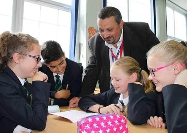 Andrew Wood, of Kal Group, helps Queen Elizabeth's students with their app design