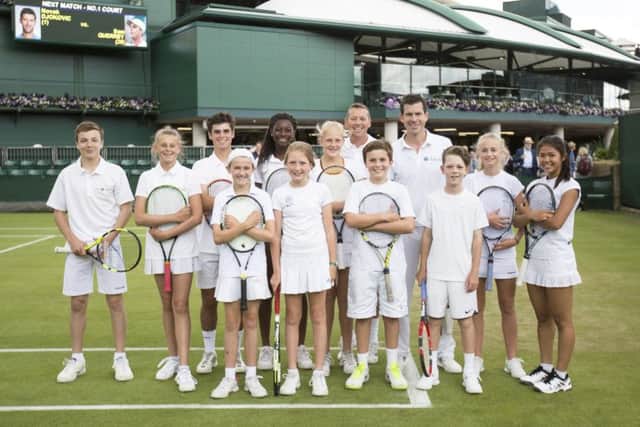 Bradley Buckland (second row, third in from left) with junior players and Tim Henman. Photo credit: onEdition.